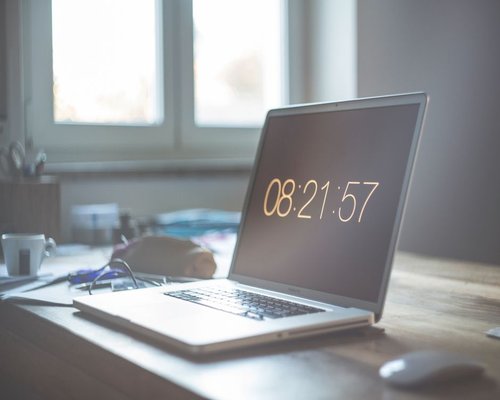 A laptop closed on a clean desk indicating the completion of home office hours for an active walk outside